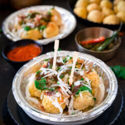 Ram ladoo in a bowl garnished with chutney and spices