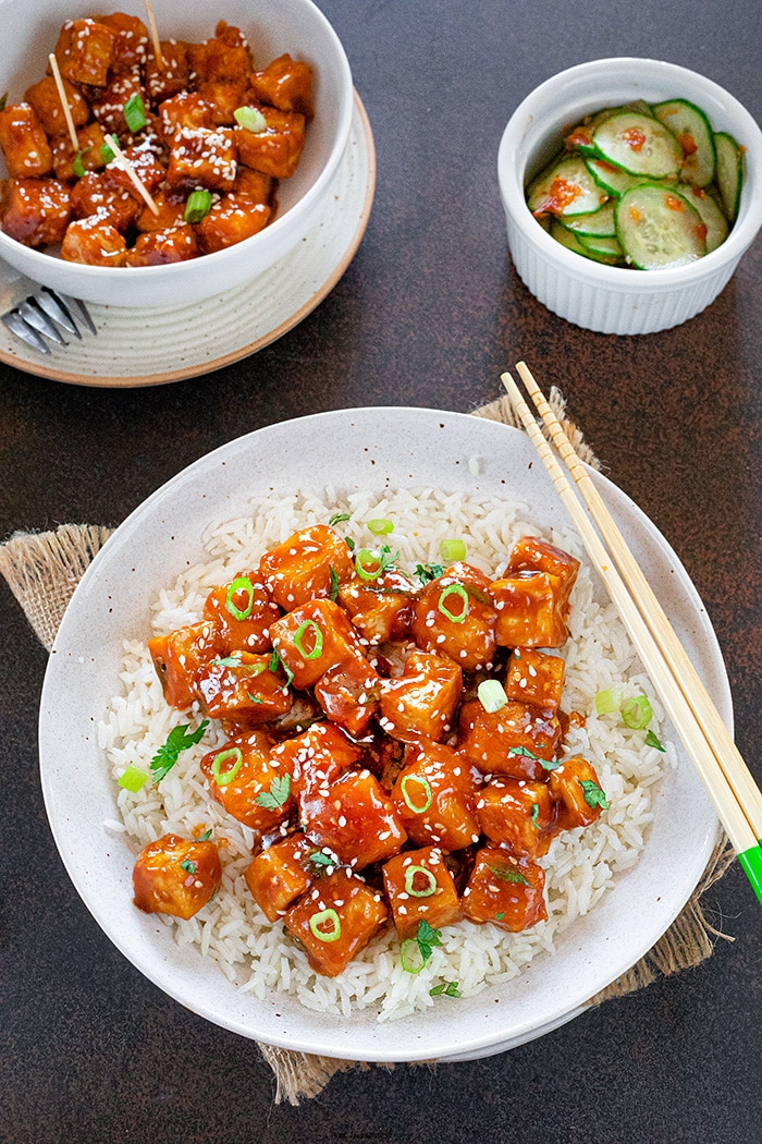 Stir-fried Sweet chili tofu over rice with chopsticks