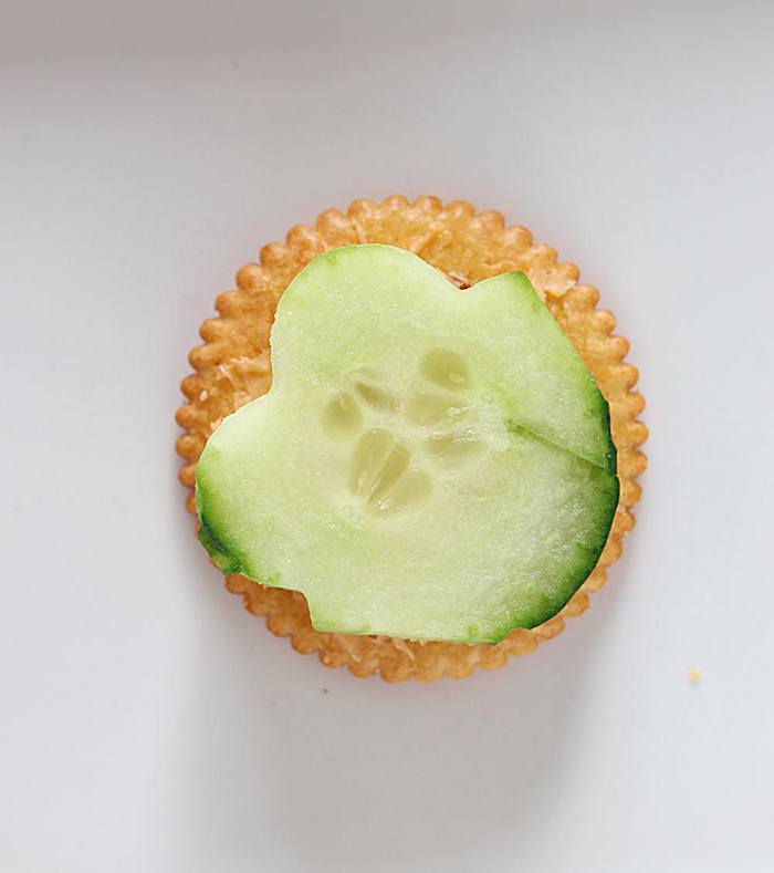 Ritz cracker topped with cucumber
